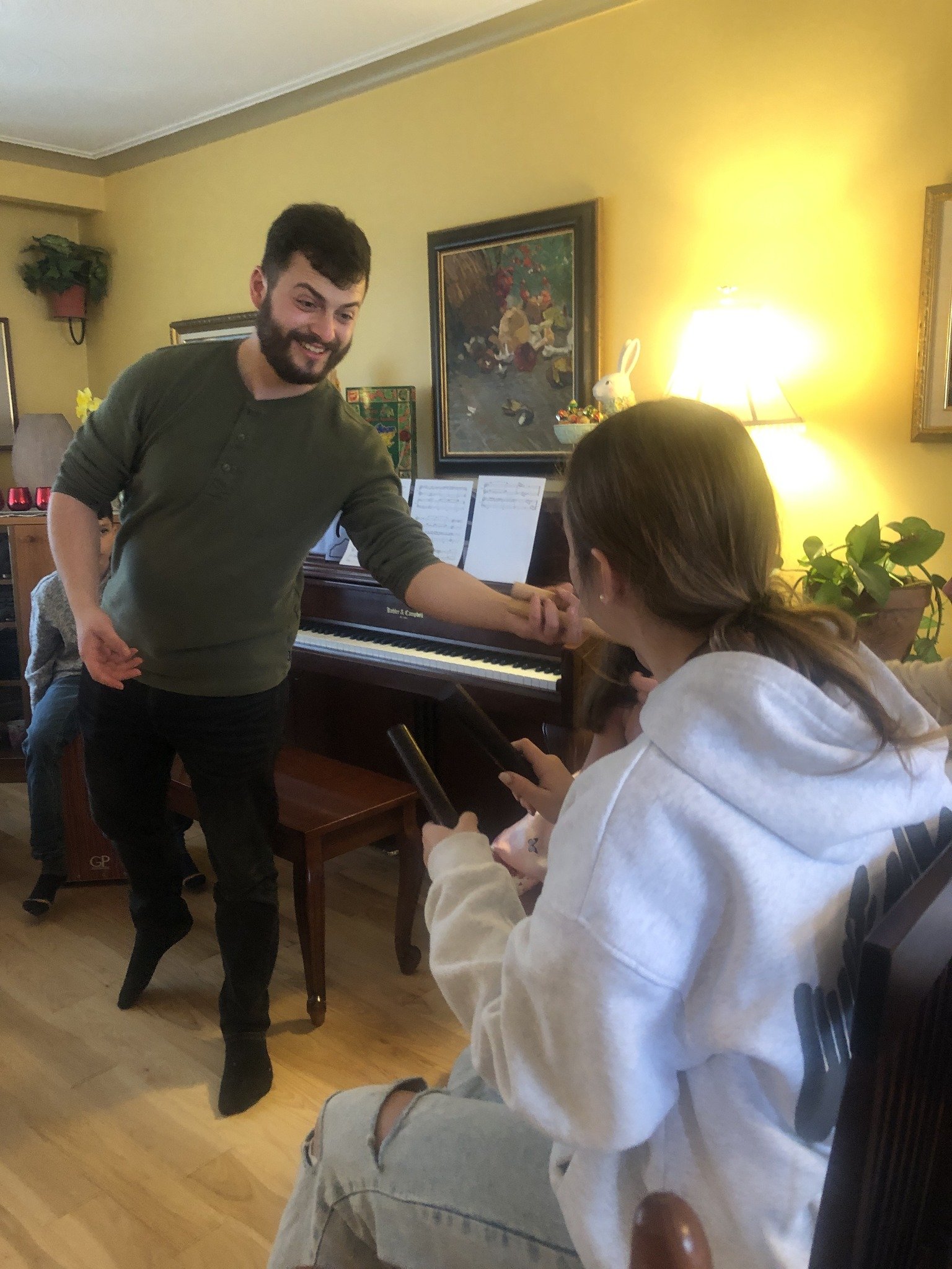 Teacher with student at piano